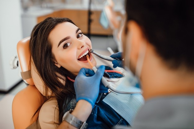 young-female-patient-visiting-dentist-office_496169-930